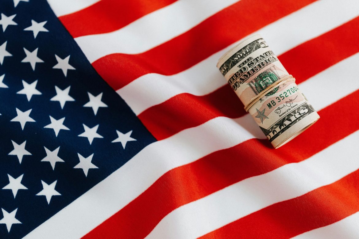 The US economy is heading into 2025 with strong momentum, but significant uncertainties could alter its trajectory. 
<a href="https://invezz.com/news/2024/12/19/the-us-economy-keeps-growing-but-for-how-long/">A strong 3% GDP growth rate in 2024</a> and the addition of nearly 2 million jobs have defied predictions of a slowdown. 
Many were once again left anticipating a recession that never came. Consumer spending and a resilient labour market have kept the economy steady. 
However, the upcoming presidency of Donald Trump, set to begin in January, is expected to bring significant policy changes that could alter this outlook.
Trade dynamics, fiscal adjustments, and geopolitical tensions are just a few of the variables that could influence the economic path forward. 
Growth will slow, but not stop
The consensus among economists is that the economy will grow at a slower pace in 2025, likely around 2%. 
This rate aligns with the long-term potential of the US economy. While soft landings are rare, the Federal Reserve’s recent monetary easing and consumer strength have built a solid foundation for continued growth. 
However, factors such as higher interest rates, rising debt levels, and geopolitical risks could act as headwinds.
What will the US Fed do next?
The Federal Reserve reduced interest rates three times in second half of 2024, lowering the terminal rate to 3%. 
Markets anticipate fewer cuts in 2025 as Fed Chair Jerome Powell focuses on maintaining stability. 
Inflation, currently at 2.4%, is near the Fed’s 2% target but could rise from here. Economists warn that additional tariffs or supply chain disruptions may push inflation higher.
A surprise rebound in inflation could lead to renewed rate hikes, raising borrowing costs for businesses and consumers. For now, markets expect the Fed to tread cautiously, balancing growth and inflation concerns. 
Meanwhile, businesses are closely watching the Fed’s actions to plan for capital investment and borrowing decisions. 
Persistent inflation above 2% could also impact consumer confidence, potentially slowing the spending that has driven much of the recent economic expansion.
Will consumers remain unfazed?
Real income growth has been a key driver of consumer spending. <a href="https://invezz.com/news/2024/12/09/why-the-us-labor-market-is-confusing-everyone/">Unemployment rose</a> slightly to 4.2% by the end of 2024, but hiring remains steady. 
Employers are hesitant to lay off workers, a trend known as labor hoarding, which helps stabilize the job market. Despite these positives, elevated consumer debt levels signal financial stress for some households.
Retailers are likely to see mixed results. High-income households may continue spending, but those in lower-income brackets could pull back. 
Inflation’s trajectory will play a crucial role in shaping consumer behavior in 2025. Rising costs in essentials such as food and energy could disproportionately affect lower-income families, adding pressure to adjust discretionary spending. 
On the other hand, continued real wage growth could mitigate these effects and sustain overall consumption levels.
Policies that could shake things up
The incoming Trump administration’s economic policies are creating uncertainties. Key proposals include new tariffs, tax cuts, and stricter immigration rules. 
Analysts expect a 90% likelihood of sweeping tariffs on imports from key trade partners like China, Mexico, and Canada. 
Historical data shows a 1% tariff increase raises inflation by 0.1%, potentially offsetting recent progress in price stability. 
Proposed tax cuts could boost corporate and household spending but may widen the budget deficit, which is projected to grow by $4.6 trillion if current policies are extended, according to the Congressional Budget Office. 
Stricter immigration policies could exacerbate labor shortages, raising costs in sectors like construction and agriculture.
The combination of these policies may create ripple effects throughout the economy. For example, increased tariffs could lead to higher costs for manufacturers and retailers, ultimately passing those costs onto consumers. 
Tax cuts, while potentially stimulating short-term growth, may reduce funding for government programs or lead to increased borrowing. 
Global tensions add uncertainty
The geopolitical landscape is anything but certain. Lots of ups and downs were observed in 2024 and the next year isn’t likely to be any different. 
Revisionist powers like China and Russia are challenging the existing world order. 
Xi Jinping’s government continues to focus on Taiwan, raising tensions in Asia. 
A perceived decline in U.S. global influence could embolden China to act more aggressively. 
Despite economic isolation, <a href="https://invezz.com/news/2024/12/24/is-russias-economy-too-fragile-to-sustain-its-war-efforts/">Putin remains committed to his vision</a> of restoring Russian influence, particularly in Ukraine. 
The U.S.’s trade and security commitments could be tested if these tensions escalate.
America’s “America First” policies may strain alliances and disrupt global trade flows, adding another layer of risk to the 2025 economic outlook. 
Businesses with global supply chains may face challenges as they navigate shifting trade policies and geopolitical instability. 
Meanwhile, increased defense spending in response to global tensions could provide a boost to certain industries, offsetting some of the broader economic risks.
Is the stock market overvalued?
US equity markets soared in 2024, with the S&P 500 delivering a 29% total return. Technology stocks once again led the rally, driven by advances in artificial intelligence. 
However, valuations are now stretched based on historical standards, with the S&P 500 trading at a forward P/E ratio of 22. Nevertheless, elevated profit margins and robust earnings growth are supporting these valuations. 
But any earnings disappointments, particularly in tech, could trigger a correction. Case in point, Nvidia’s third-quarter results in 2024 led to a 10% drop in its stock price due to unmet expectations.
For 2025, sector rotation and a closer look at other countries which are now trading at a discount in comparison to the U.S. are becoming favored strategies by experienced portfolio managers.
Are bonds cool again?
With 10-year Treasury yields at 4.6%, bonds now offer reasonable risk-adjusted returns. Long-term inflation expectations of 2.3% suggest that real yields remain attractive for conservative investors. Bonds are also regaining their role as a hedge against stock market volatility.
Corporate debt levels will remain a concern in 2025, particularly in rate-sensitive sectors like housing and utilities. However, strong earnings and productivity gains provide some buffer.
A year to watch closely
The US economy is entering 2025 with solid footing but faces significant risks. 
Policymakers must balance sustainable growth with inflation control, while investors are still enjoying the market’s gains over the past few years. 
Resilient consumer spending, stable corporate earnings, and moderated inflation will be critical factors in determining whether the economy can maintain its current momentum
The key question remains: can resilience outpace the challenges? If there’s one economy that can, that is certainly the American economy.
The post <a href="https://invezz.com/news/2024/12/31/will-the-us-economy-and-the-stock-market-continue-their-growth-into-2025/">Will the US economy and the stock market continue their growth into 2025?</a> appeared first on <a href="https://invezz.com/">Invezz</a> Will the US economy and the stock market continue their growth into 2025?